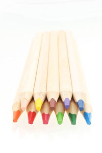 Close-up of multi colored pencils against white background