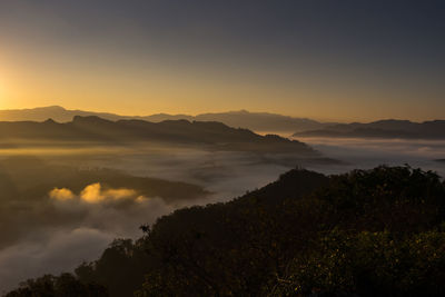 Scenic view of silhouette mountains against sky during sunset