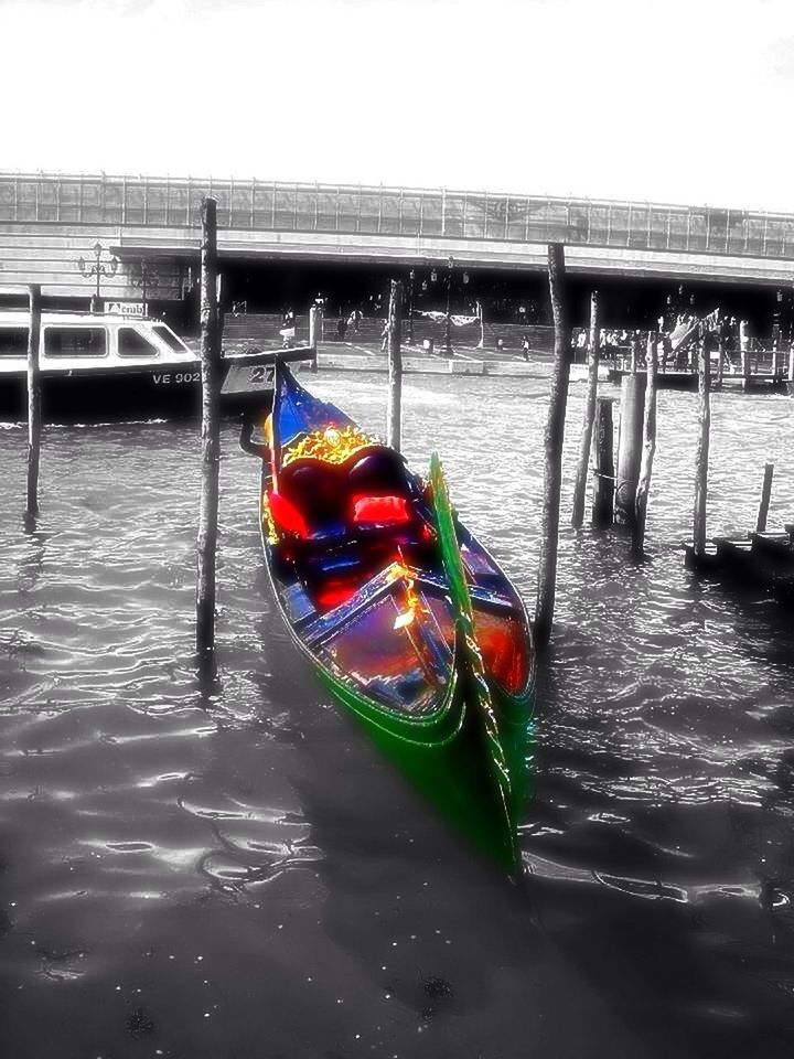 water, waterfront, nautical vessel, transportation, boat, mode of transport, reflection, built structure, moored, rippled, architecture, river, lake, building exterior, outdoors, canal, day, multi colored, no people, nature