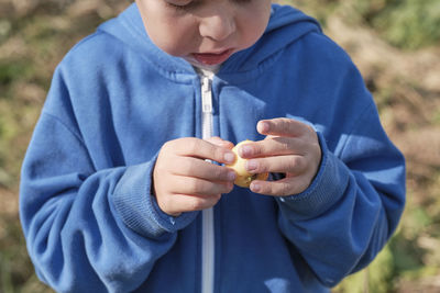 Little boy holding a hell apple in his hands, close-up