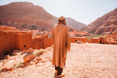 Rear view of a woman with a mountain in the background