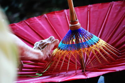 Cropped wrinkled hand of person making umbrella