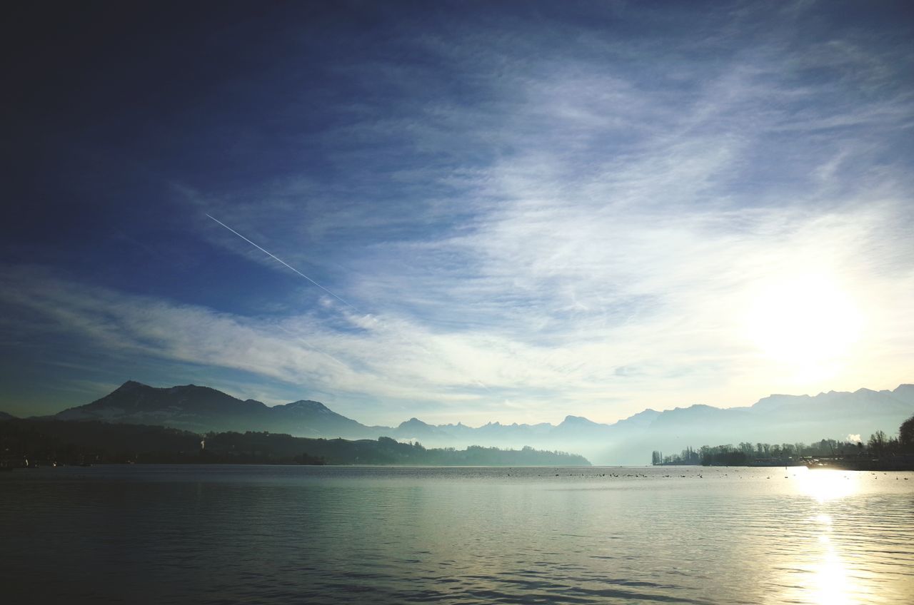 mountain, water, tranquil scene, mountain range, scenics, tranquility, sky, beauty in nature, lake, waterfront, cloud - sky, nature, reflection, idyllic, cloud, river, sea, non-urban scene, sunset, outdoors