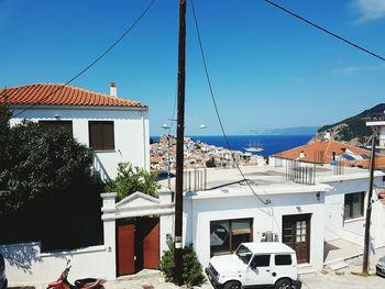 Residential district by sea against sky