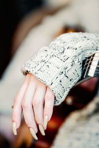 Cropped hand of person wearing gloves