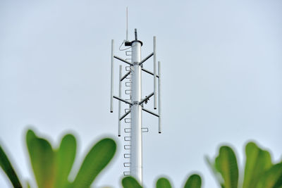 Close-up of communications tower against sky