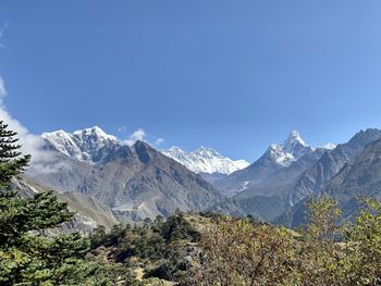 Scenic view of snowcapped mountains against clear blue sky