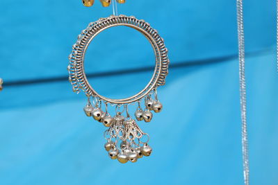 Low angle view of decoration hanging against blue wall