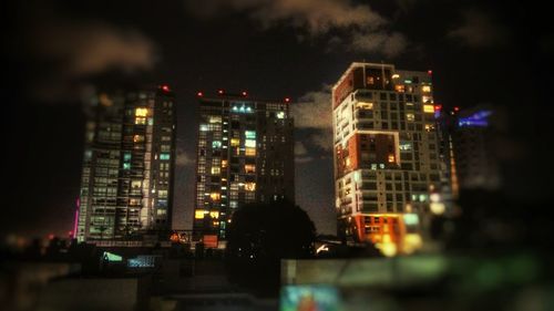 View of skyscrapers lit up at night