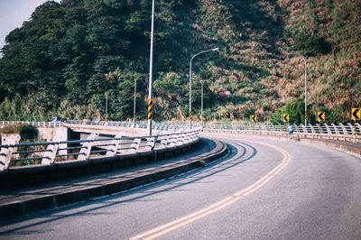 Empty road along trees