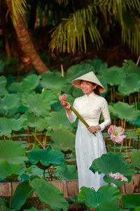 Woman standing by plants