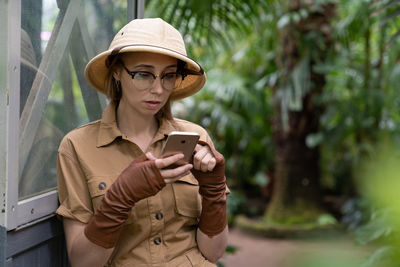 Woman using phone while standing outdoor