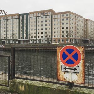 Road sign against building in city