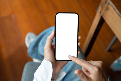 Midsection of woman using mobile phone