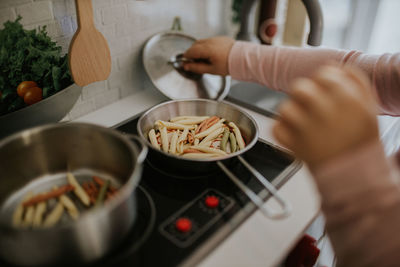 Midsection of child preparing food at home