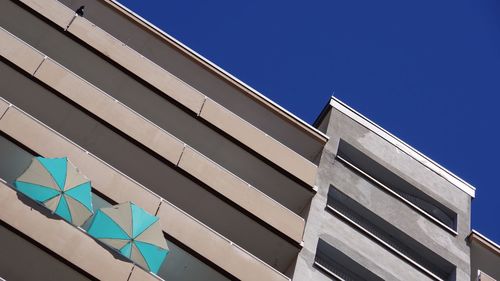 Low angle view of building against clear blue sky