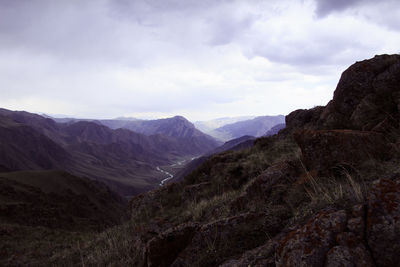 Scenic view of mountains against cloudy sky