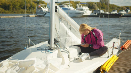 Woman sitting on boat in sea