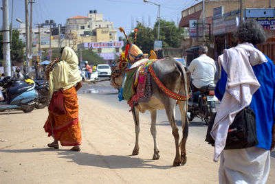 Panoramic view of people in city against sky