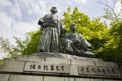 Low angle view of statue against sky