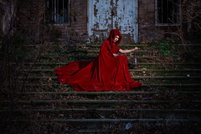 Woman standing by staircase