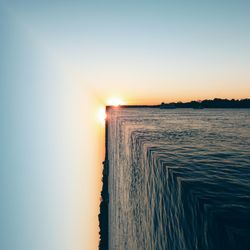 Scenic view of sea against clear sky during sunset