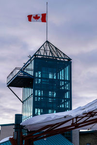 Low angle view of building against cloudy sky