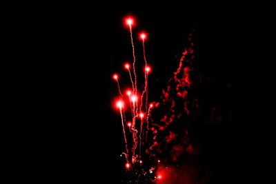 Low angle view of firework display at night