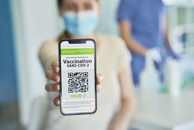 Midsection of man using mobile phone