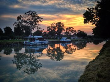 Scenic view of river at sunset