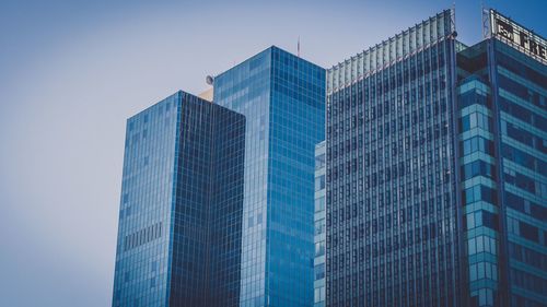 Low angle view of skyscrapers against clear blue sky