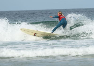 Woman surfing in sea