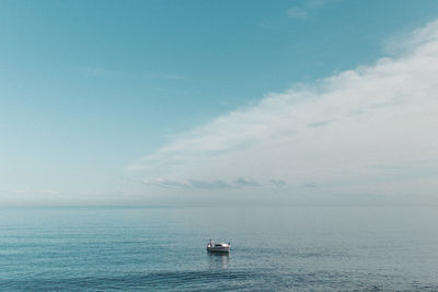 Boat sailing in sea against sky