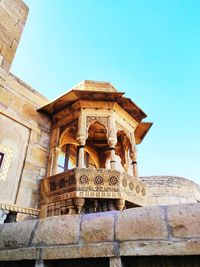 Low angle view of historical building against clear blue sky