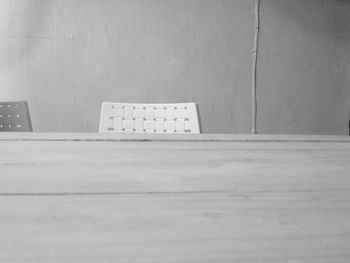 Empty seats on wall against building