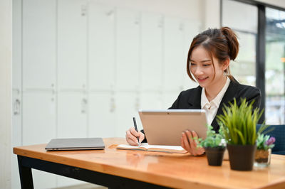 Businesswoman using laptop at office