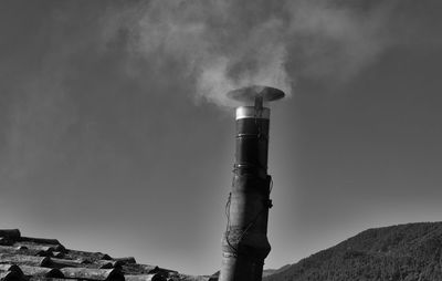 Low angle view of smoke stack against sky