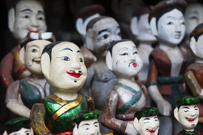 Close-up of wooden puppets for sale at market stall
