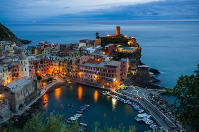 High angle view of buildings and sea at cinque terre during dusk