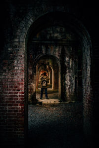 Boy standing in archway