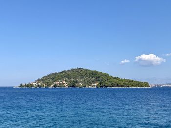 Scenic view of sea against blue sky