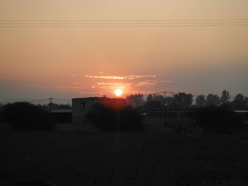 Scenic view of field against sky during sunset