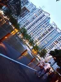 High angle view of buildings and trees in city