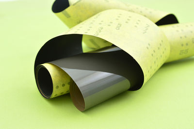 Close-up of yellow paper over white background