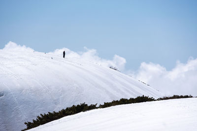 Scenic view of snow covered field against sky