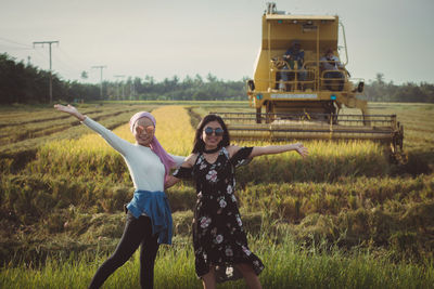 Full length of women standing on a paddy field