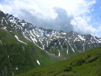 Scenic view of mountains against cloudy sky