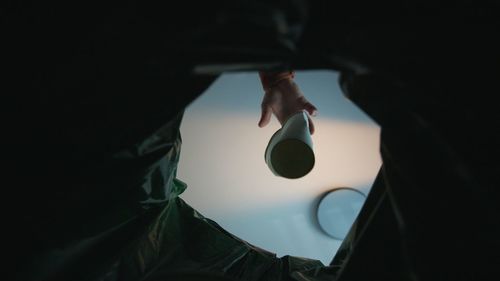 Cropped hand of woman holding rubbish