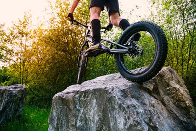 Man riding bicycle on rock