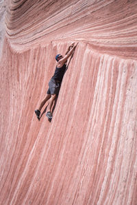 Full length of man climbing on rock formation